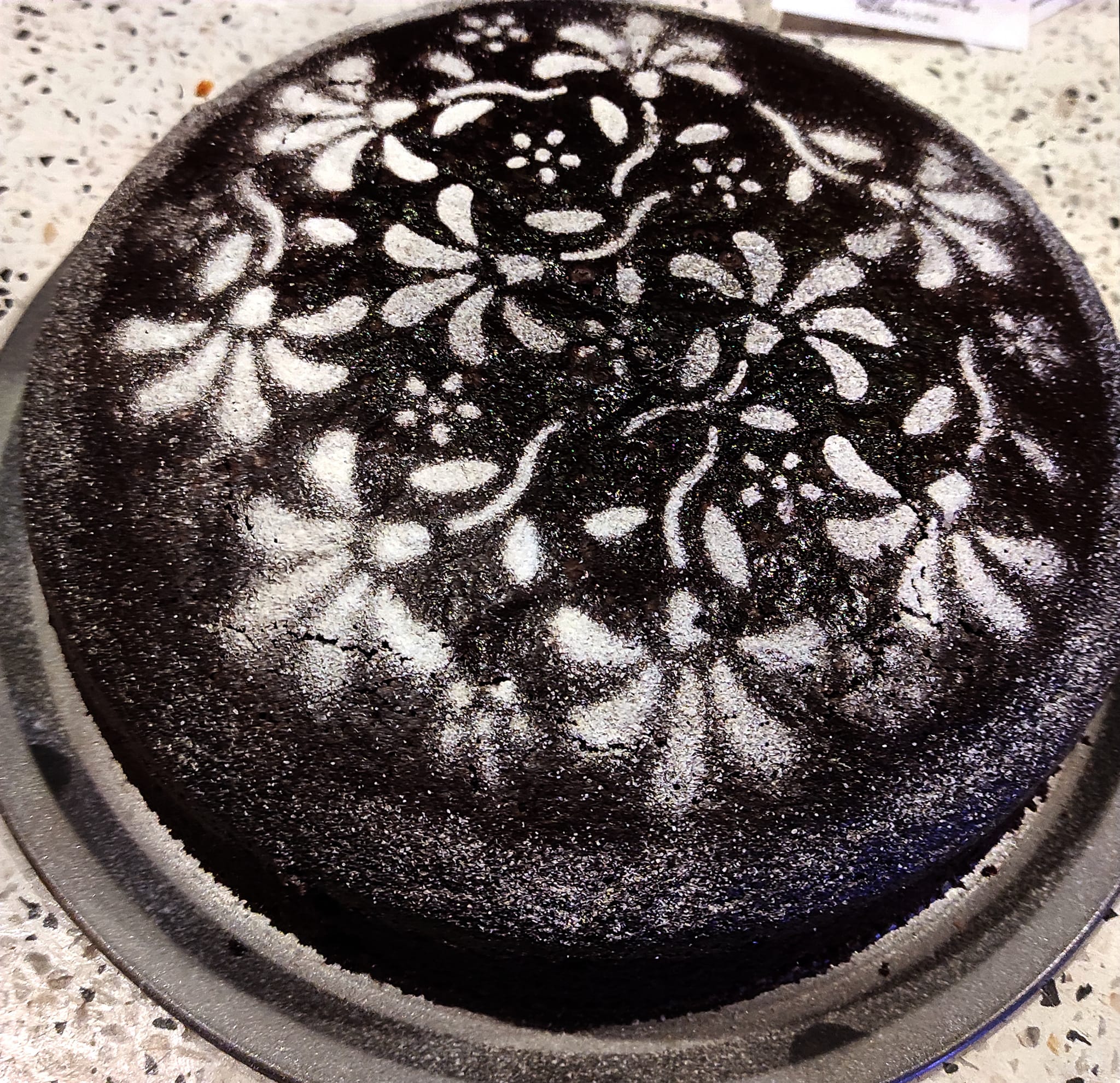 Artisan chocolate cake with powdered sugar design