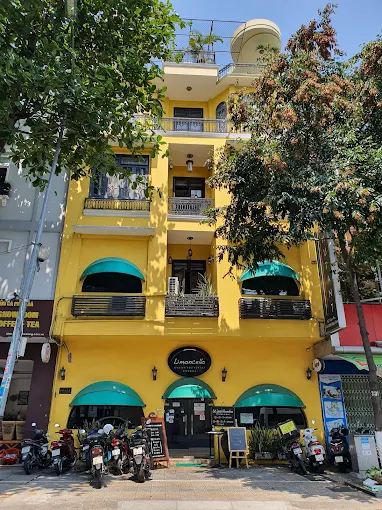 Limoncello building facade - the iconic yellow building with green awnings