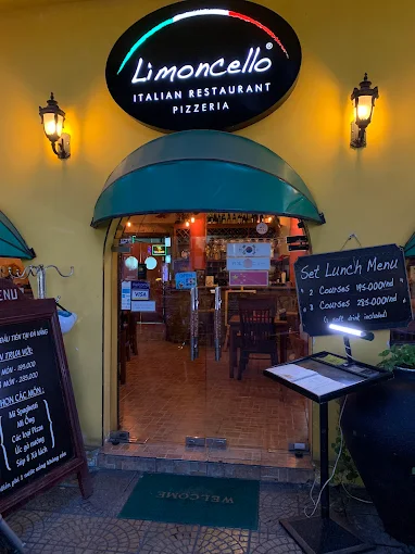 Limoncello entrance with green awning at night